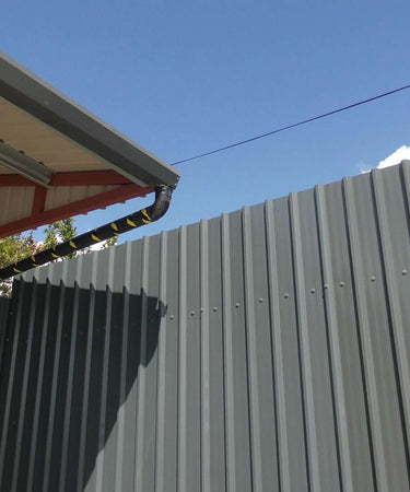 Self-hanging galvanised gutter on box profile roof sheeting, Ireland