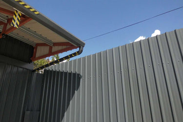 Self-hanging galvanised gutter on box profile roof sheeting, Ireland