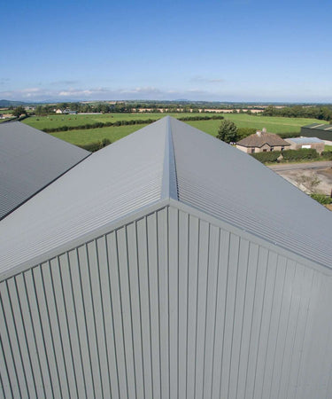 Aerial view of commercial building showing ridge capping on corrugated roof, Ireland